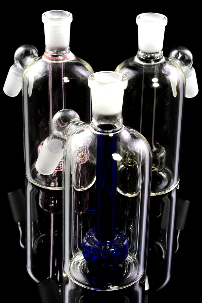 Trio of 14.5 mm 45-degree ash catchers with colored showerhead percs in pink, blue, and black, grouped on glossy black backdrop.