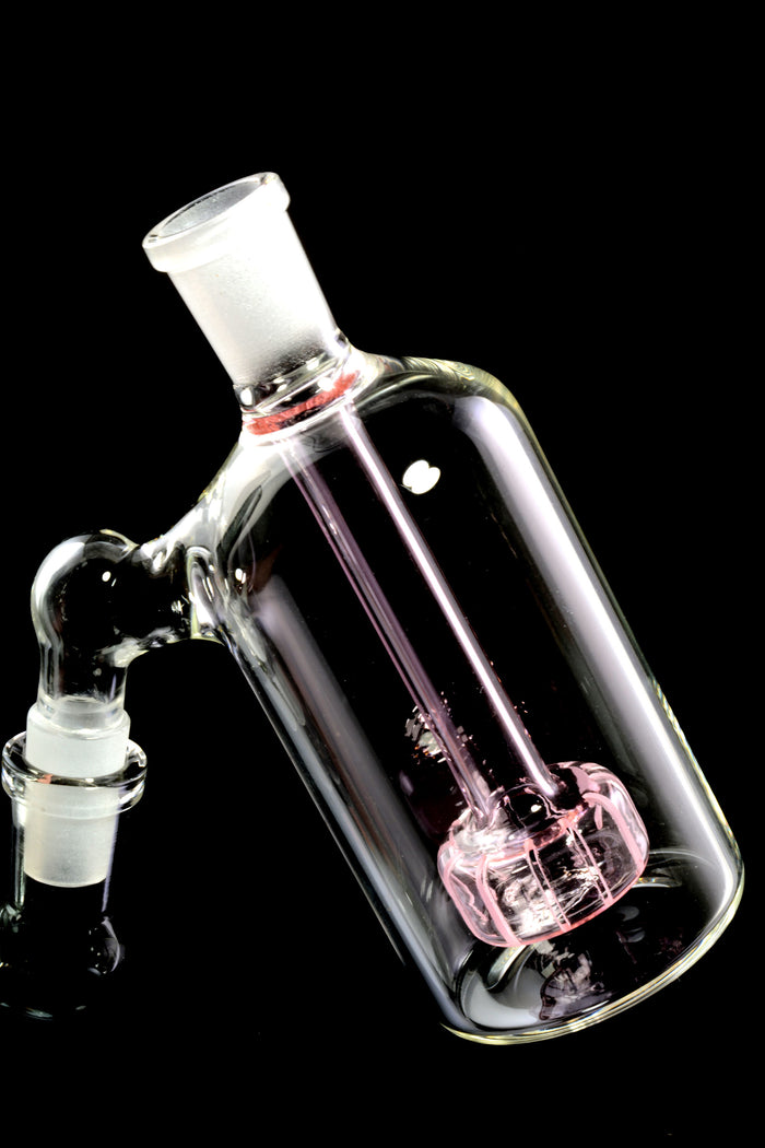 Angled pink-perc ash catcher highlighting 45-degree joint orientation and colored showerhead base on black backdrop.